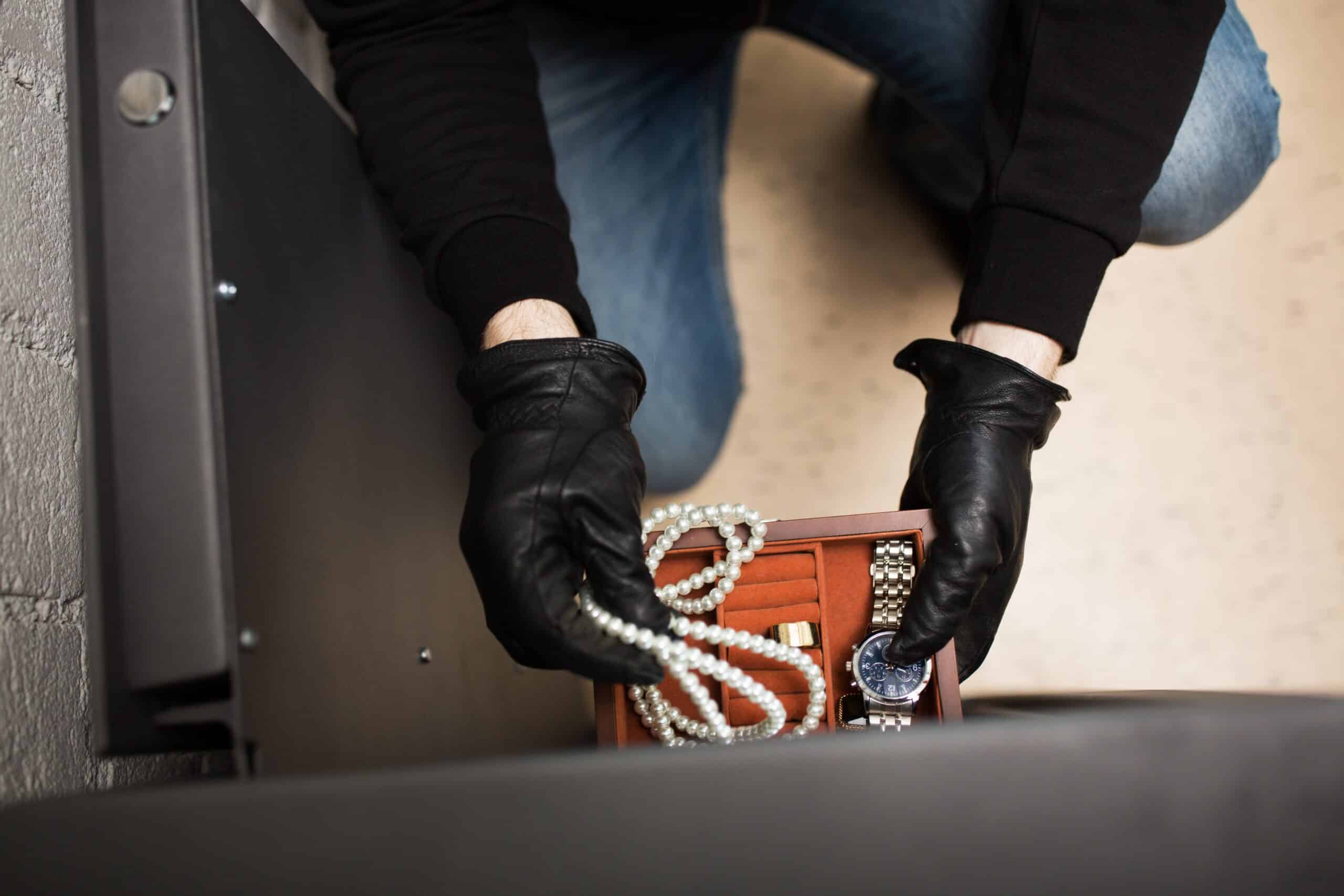 Person With Black Gloves Trying To Steal Jewellery