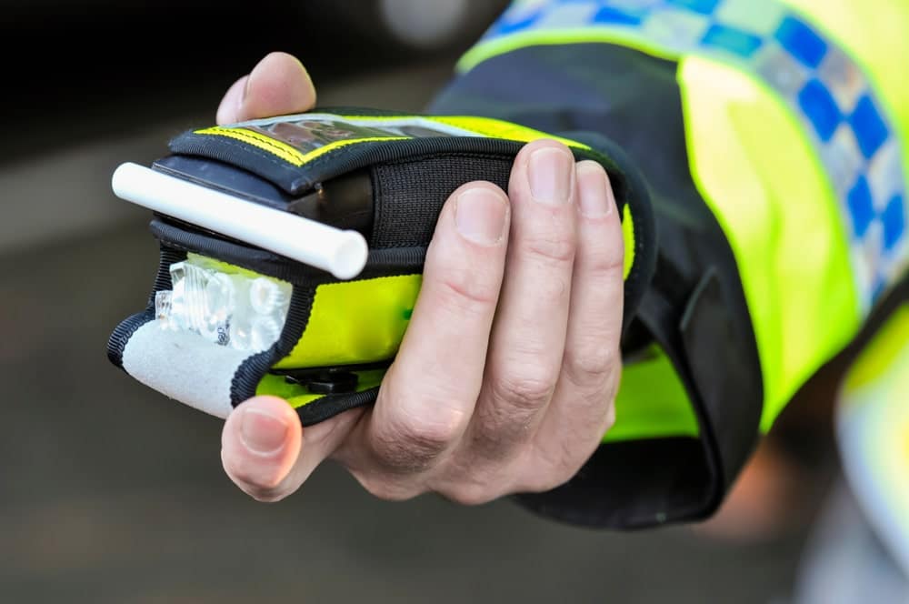 Police Officers Hand Holding A Breathalyser